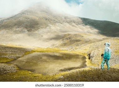 Aerial cinematic view hiker trekking stand on viewpoint in Georgia visit special alpine Sakori lake high in caucasus mountains in Georgia. Misty lake outdoors explore caucasus - Powered by Shutterstock