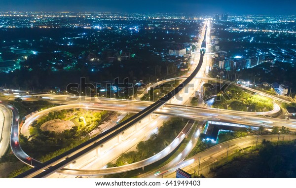 Aerial city view with\
cross roads and roads on air, Express ways, buildings, parks and\
parking lots, bridges. Urban landscape. , toll way, high way ,\
roads in the city.