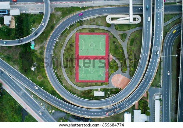 Aerial city view with cross roads and roads, Express\
ways, buildings, parks and parking lots, bridges. Urban landscape.,\
roads in the city.Aerial city view with cross road and road on\
air.