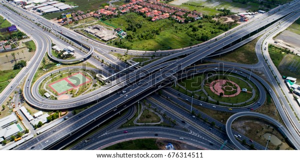 Aerial city view with cross roads and roads, Express\
ways, buildings, parks and parking lots, bridges. Urban landscape.,\
roads in the city.Aerial city view with cross road and road on\
air.