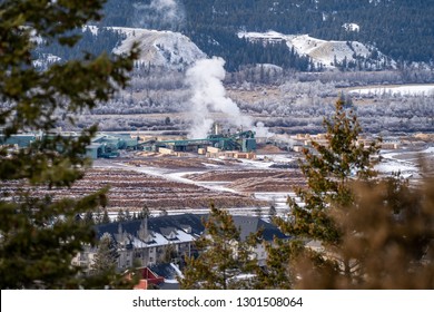 Aerial citycape view of Radium Hot Springs, British Columbia Canada in the winter, with a natural frame on housing and the lumber mill