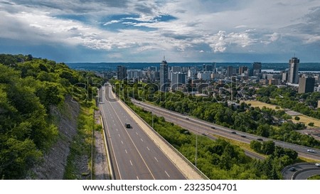 An aerial of the cityscape of Hamilton, Ontario with a display of a highway