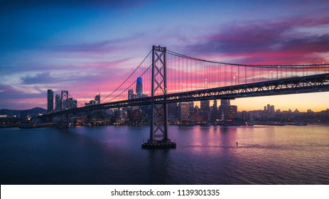 Aerial Cityscape view of San Francisco and the Bay Bridge with Colorful Sunset, California, USA