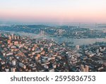 Aerial cityscape of Vladivostok at sunset showcasing urban development and the famous bridges connecting urban areas