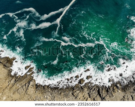 Aerial close up of the turquoise sea at the coast of the National Park Pan de Azúcar in the Atacama desert in Chile - Traveling South America