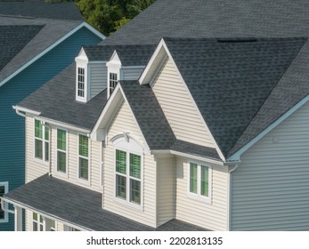 Aerial Close Up View Of Luxury House Façade With Double Gable Roof, Two Decorative Attic Dormer Windows 