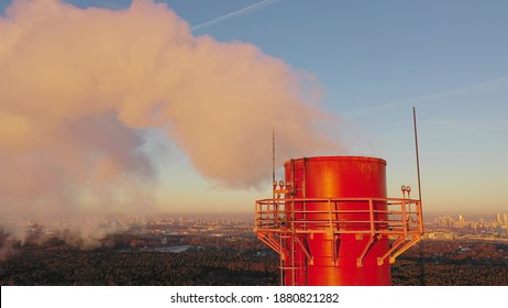 Aerial Close-up View Of An Air Polluting Industrial Red Smoke Stack