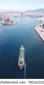 Aerial Drone, Bird's Eye Photo Of Industrial Tanker Ship Entering Famous Port Of Peiraeus, One Of The Largest In Europe, Attica, Greece