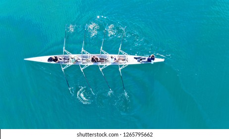 Aerial drone bird's eye view of sport canoe operated by team of young men in turquoise clear waters - Shutterstock ID 1265795662
