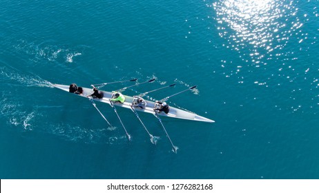 Aerial drone bird's eye view of sport canoe operated by team of young women in turquoise clear waters - Shutterstock ID 1276282168