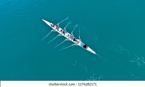 Aerial drone bird's eye view of sport canoe operated by team of young women in turquoise clear waters - Shutterstock ID 1276282171
