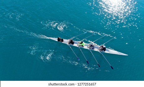 Aerial drone bird's eye view of sport canoe operated by team of young men in emerald clear sea - Powered by Shutterstock