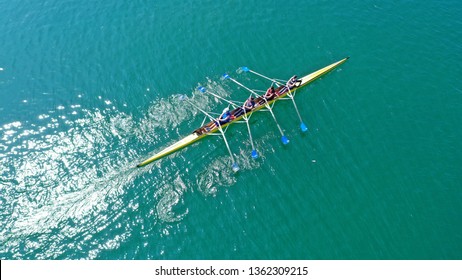 Aerial drone bird's eye view photo of yellow sport canoe operated by team of young team in emerald clear sea - Powered by Shutterstock