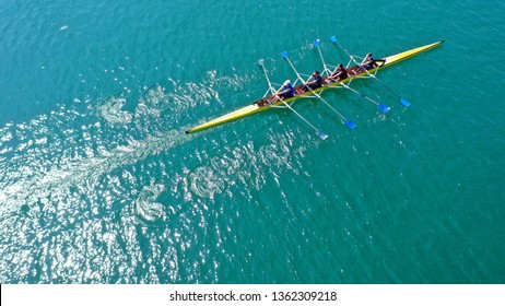 Aerial drone bird's eye view photo of yellow sport canoe operated by team of young team in emerald clear sea - Powered by Shutterstock