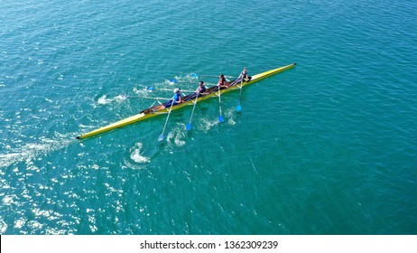 Aerial Drone Bird's Eye View Photo Of Yellow Sport Canoe Operated By Team Of Young Team In Emerald Clear Sea