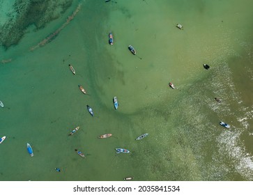 Aerial drone bird's eye view photo Top down of tropical sea with long tail fishing boats Travel boats at phuket thailand Amazing top view drone sea