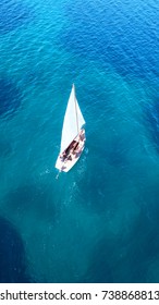 Aerial Drone, Bird's Eye View Of Yacht Cruising In Tropical Turquoise And Sapphire Sea