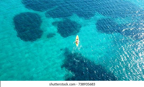 Aerial Drone Bird's Eye View Of Kayak Cruising In Tropical Rocky Seascape With Turquoise And Sapphire Clear Waters