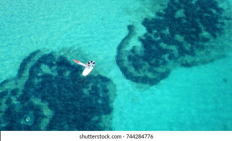 Aerial Drone Bird's Eye View Of Surfer In Tropical Clear Water Beach