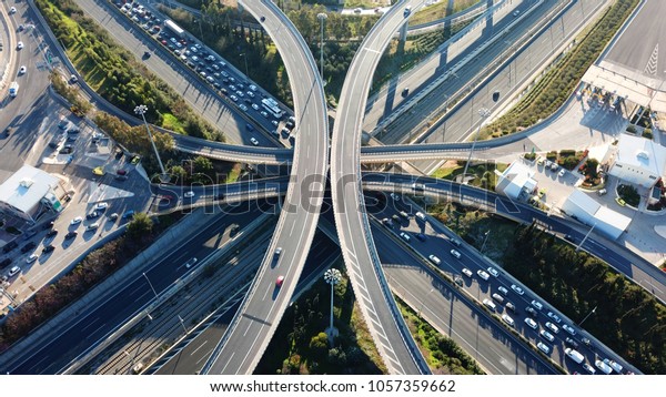 Aerial\
drone bird\'s eye view photo of latest technology cross shape multi\
level road highway passing through city\
center