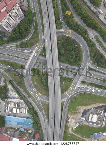 Aerial\
drone bird\'s eye view photo of latest technology cross shape multi\
level road highway passing through city\
center.