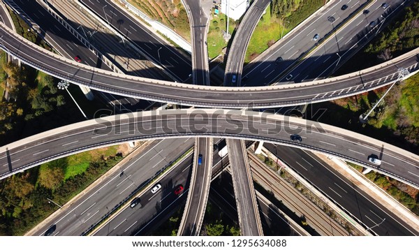 Aerial\
drone bird\'s eye view photo of latest technology cross shape multi\
level road highway passing through city\
centre