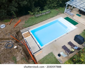 Aerial Drone Flight Of Pool Build Construction Site With Pool Filled With Water