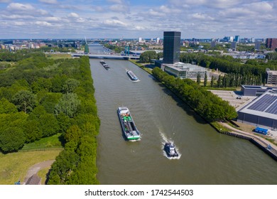aerial drone footage of canal in the province of Utrecht with inland freight ships passing by. The Netherlands. inland vessel. in the back is the A12 highway with the prins clausbrug / galecopperbrug