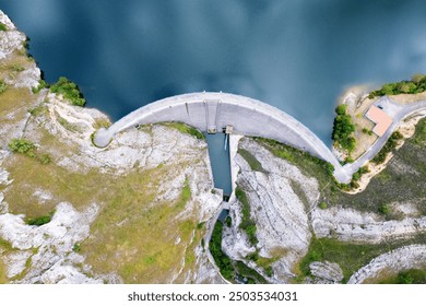 Aerial drone footage Water dam and reservoir lake, generating hydro electricity power renewable energy and sustainable development. - Powered by Shutterstock