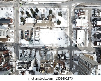 Aerial Drone Image Of Downtown Hamilton, Ontario, Canada During Winter With Apartment Buildings And Low Rise Housing Covered In Snow.