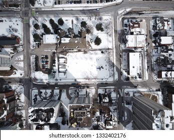 Aerial Drone Image Of Downtown Hamilton, Ontario, Canada During Winter With Apartment Buildings And Low Rise Housing Covered In Snow.