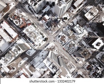 Aerial Drone Image Of Downtown Hamilton, Ontario, Canada During Winter With Apartment Buildings And Low Rise Housing Covered In Snow.