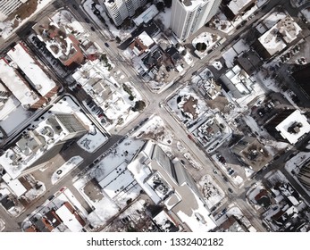 Aerial Drone Image Of Downtown Hamilton, Ontario, Canada During Winter With Apartment Buildings And Low Rise Housing Covered In Snow.