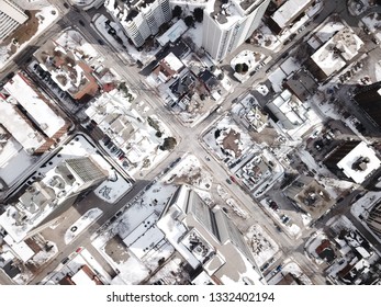 Aerial Drone Image Of Downtown Hamilton, Ontario, Canada During Winter With Apartment Buildings And Low Rise Housing Covered In Snow.