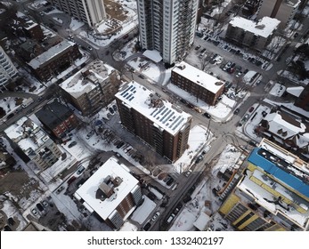 Aerial Drone Image Of Downtown Hamilton, Ontario, Canada During Winter With Apartment Buildings And Low Rise Housing Covered In Snow.