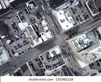 Aerial Drone Image Of Downtown Hamilton, Ontario, Canada During Winter With Apartment Buildings And Low Rise Housing Covered In Snow.