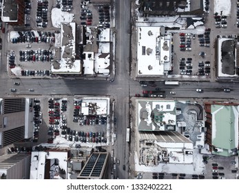 Aerial Drone Image Of Downtown Hamilton, Ontario, Canada During Winter With Apartment Buildings And Low Rise Housing Covered In Snow.