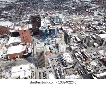 Aerial Drone Image Of Downtown Hamilton, Ontario, Canada During Winter With Apartment Buildings And Low Rise Housing Covered In Snow.