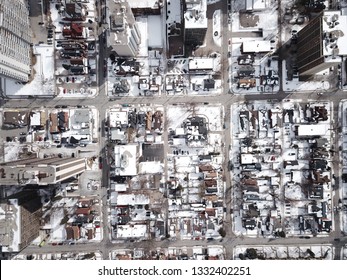 Aerial Drone Image Of Downtown Hamilton, Ontario, Canada During Winter With Apartment Buildings And Low Rise Housing Covered In Snow.