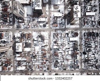 Aerial Drone Image Of Downtown Hamilton, Ontario, Canada During Winter With Apartment Buildings And Low Rise Housing Covered In Snow.