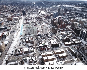 Aerial Drone Image Of Downtown Hamilton, Ontario, Canada During Winter With Apartment Buildings And Low Rise Housing Covered In Snow.