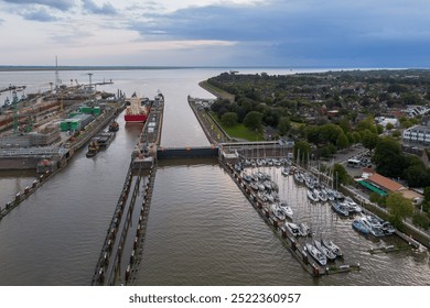 Aerial drone image of the lock complex sluice and Elbe port of Brunsbüttel under construction, the entrance of the nord ostsee kanal the Kiel canal from the north sea to baltic cargo ship container
