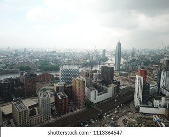 Aerial Drone Image Of London England And The River Thames On A Clear Sunny Day.  Skyscrapers Shape The London Skyline Looking East.