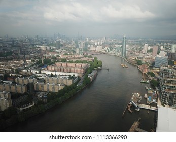 Aerial Drone Image Of London England And The River Thames On A Clear Sunny Day.  Skyscrapers Shape The London Skyline Looking East.