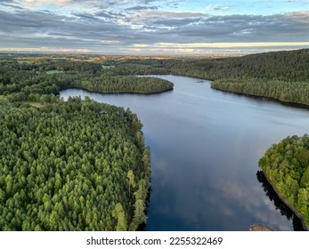 Aerial drone image over the lake in the middle of the forest. Image captured in the Halland county in Halmstad municipality in southern Sweden. Popular travel destination and recreation place  - Shutterstock ID 2255322469