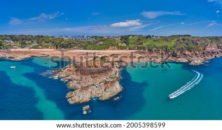 Aerial Drone image of Portelet Bay, Jersey, Channel Islands with blue sky and calm water.