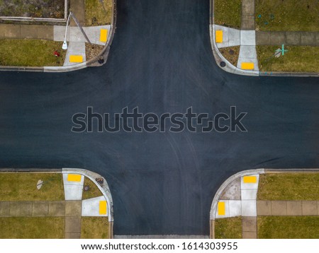 Aerial drone image of a road intersection looking straight down without vehicles
