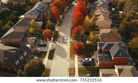 Aerial drone image of suburbia during autumn with brilliant colors showing.