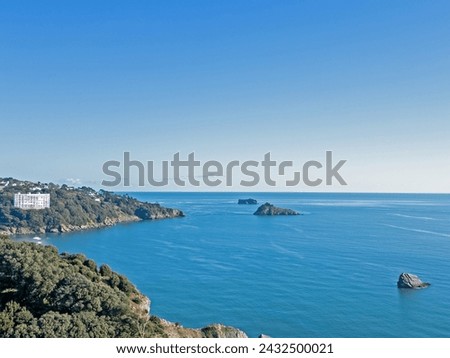 Aerial drone image of the view of Tor Bay Torquay over Meadfoot Beach showing a calm blue sea surrounding Thatcher's Rock and Ore Stone in the distance on a clear sunny day Stock fotó © 