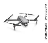 Aerial Drone Isolated on White Background. Top Side Front View Quad Copter with Digital Camera. Flying Remote Control Air Drone. Headless Quadcopter with 4K Hasselblad Camera and Remote Control